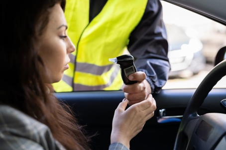 Woman about to use a Breathalyzer